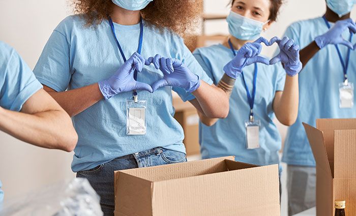 Volunteers making a heart shape with their hands