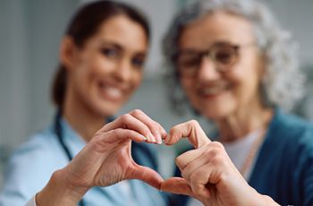 Two women with hand heart shape